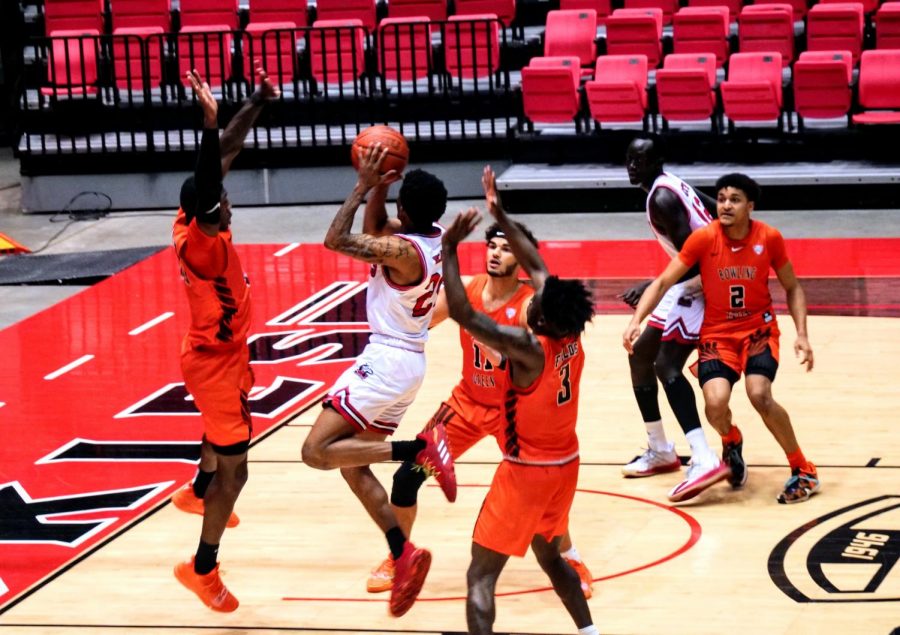NIU junior guard Darius Beane, second from left, attempts a close jumpsuit off the dribble Jan. 2, during NIUs 68-42 loss to Bowling Green State University at the NIU Convocation Center in DeKalb. Beane would hit the game winning-shot in the game against the University of Akron Zips Tuesday.