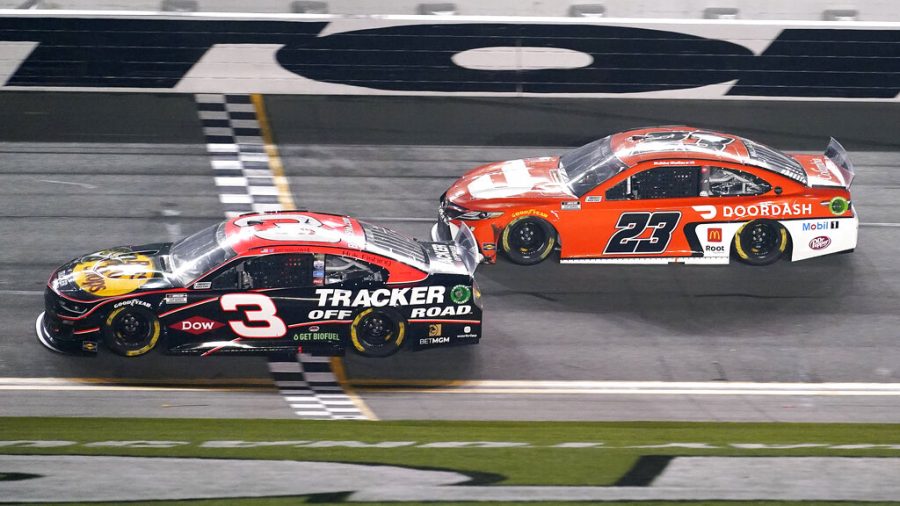 Austin Dillon (3) crosses the finish line in front of Bubba Wallace (23) to win the second of two qualifying auto races for the NASCAR Daytona 500 at Feb. 12, 2021, at Daytona International Speedway, in Daytona Beach, Florida.