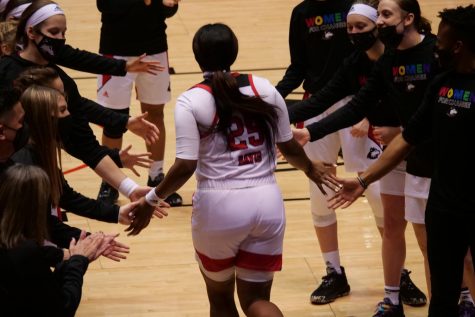 NIU junior forward AJah Davis (center) high-fives her teammates Feb. 3, 2021 during the announcement of the starting lineups at the NIU Convocation Center in DeKalb.