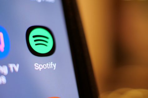Spotify logo on a computer with a blurry background.