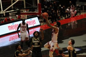 NIU junior guard Darius Beane (second from right) goes up for a layup March 2, during NIUs 73-63 loss to the Western Michigan University Broncos at the NIU Convocation Center in DeKalb.