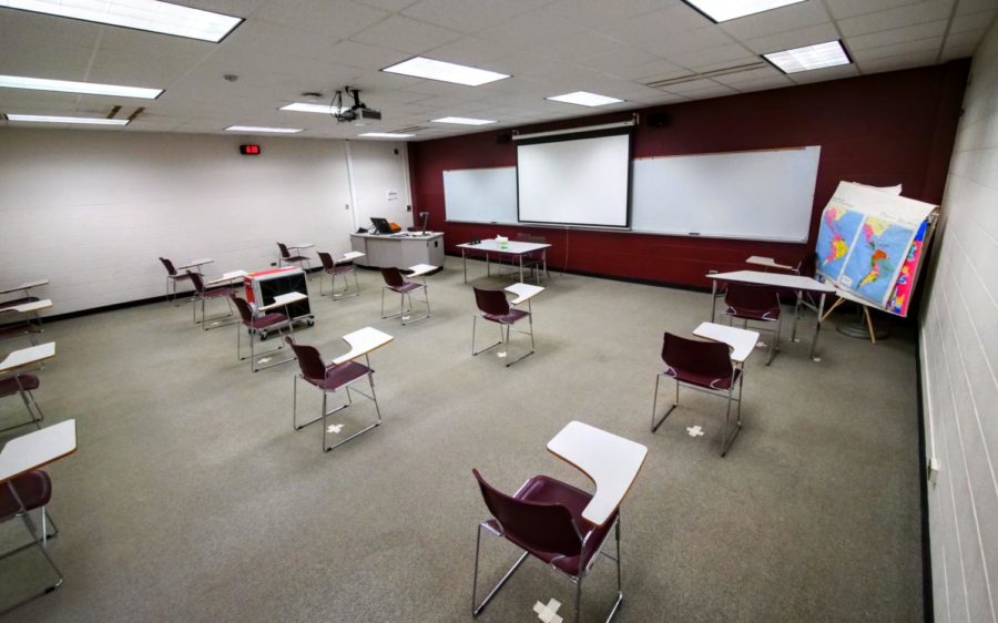 Desks in DuSable Hall are socially distanced and marked by tape on the ground.