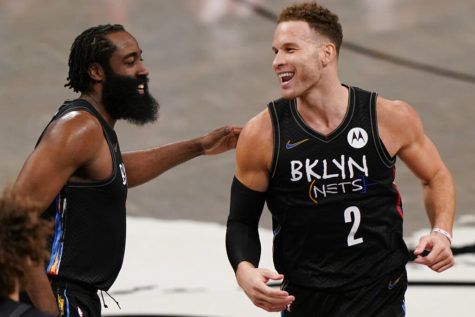 Brooklyn Nets guard James Harden (left) congratulates new teammate Brooklyn Nets forward Blake Griffin (right) March 21, after Griffin scored his first two points as a Net during the fourth quarter of an NBA basketball game against the Washington Wizards in New York.