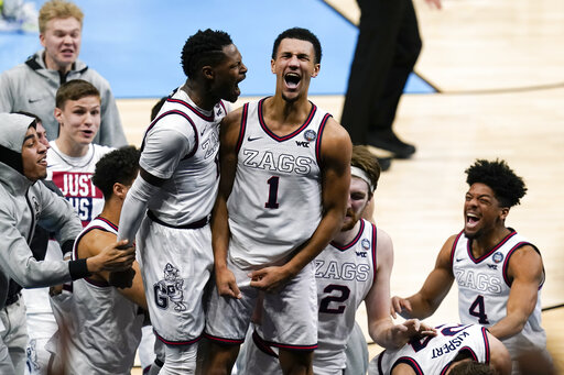 Gonzaga guard Jalen Suggs (center) celebrates making the game winning basket with Joel Ayayi (left) against UCLA April 3, during overtime in a mens Final Four NCAA college basketball tournament semifinal game, at Lucas Oil Stadium in Indianapolis. Gonzaga won 93-90.