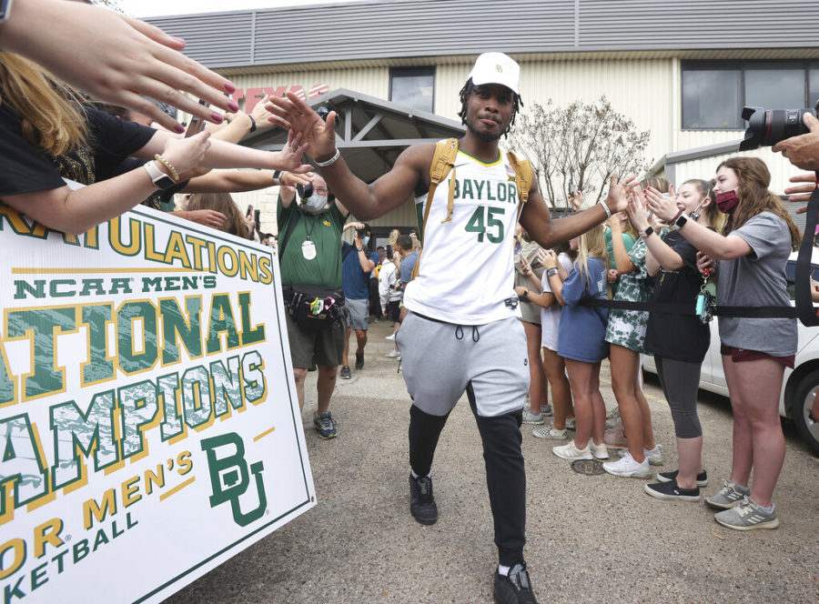 Baylor+junior+guard+Davion+Mitchell+slaps+hands+with+fans+after+arriving+home+as+NCAA+college+basketball+champions+April+6%2C+2021%2C+in+Waco%2C+Texas.