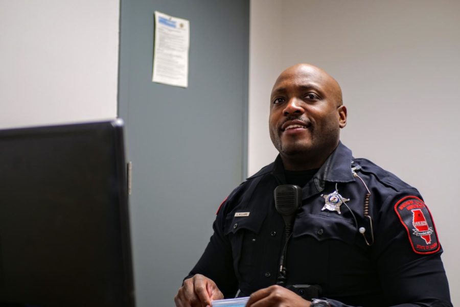 NIU police officer Larry Williams puts his face mask on a desk Thursday in an office in Stevenson Hall.