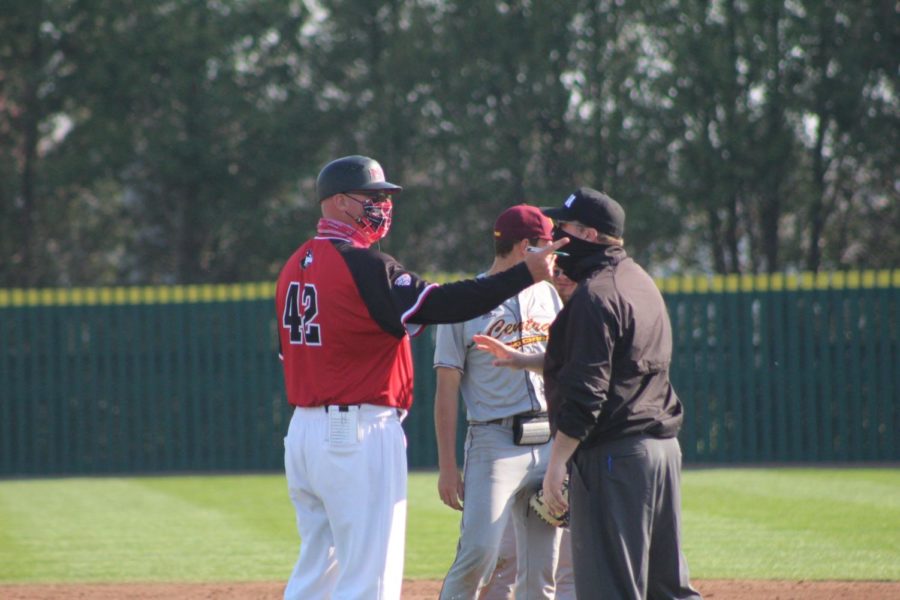 NIU head baseball coach Mike Kunigonis has a discussion with an umpire during an April 3 game against the Central Michigan Chippewas at Ralph McKinzie Field.