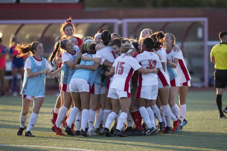 The NIU women's soccer team mobs then-graduate student forward Haley Hoppe after scoring the winning goal against Indiana State on Aug. 22, 2021, in DeKalb. Hoppe's goal in the 104th minute gave the Huskies their first victory of the 2021 season.