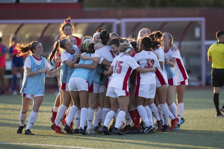 The NIU womens soccer team mobs then-graduate student forward Haley Hoppe after scoring the winning goal against Indiana State on Aug. 22, 2021, in DeKalb. Hoppes goal in the 104th minute gave the Huskies their first victory of the 2021 season.