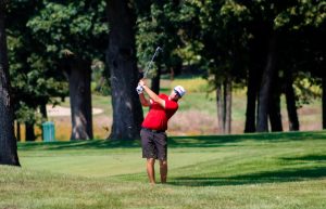 Senior Reece Nilsen hits an approach shot from the rough, Aug. 28 at Rich Harvest Farms during a fall qualifier. Nilsen returns with high hopes of contributing to the mens program.