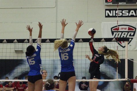 Junior outside hitter Katie Jablonski (right) attempts to spike the ball over a a wall of Air Force players in the Huskies 3-0 win at Victor E. Court on Aug. 28.
