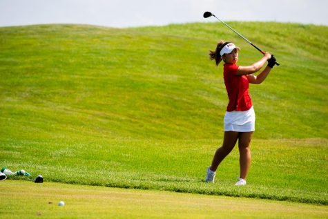 Sophomore Jasmine Ly hits an approach shot into a green during a qualifying round at Rich Harvest Farms Aug. 28