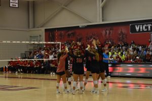 The volleyball team huddles during the first set of their matchup on Sept. 18 against Wisconsin. 