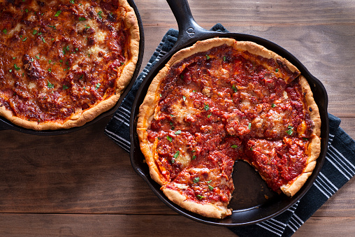 Chicago-style deep dish pizza in a cast Iron skillets.