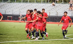 The mens soccer team celebrates a goal by redshirt junior  Enrique Banuelos (middle, 9) on Aug. 26.