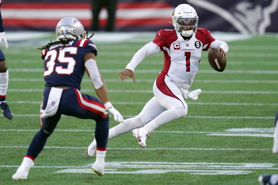 Arizona Cardinals quarterback Kyler Murray scrambles away from New England Patriots defensive back Kyle Dugger, left, in the second half of an NFL football game, Sunday, Nov. 29, 2020, in Foxborough, Mass. 