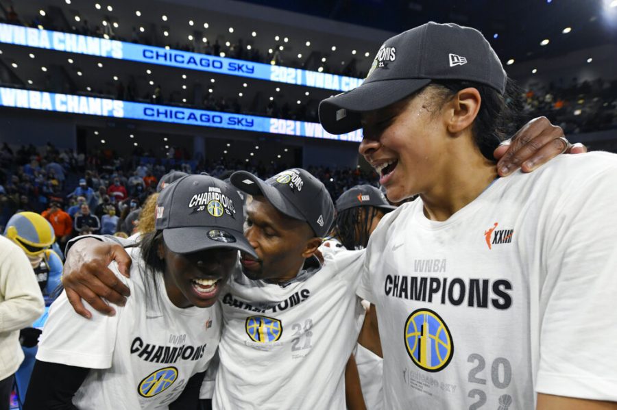 Chicago Sky head coach James Wade, center, celebrates with Candice Parker, right, and Kahleah Copper, left, after defeating the Phoenix Mercury in Game 4 of the WNBA Finals to become champions Sunday, Oct. 17, 2021, in Chicago. 