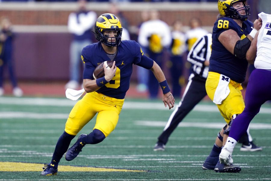 Michigan quarterback J.J. McCarthy scrambles during the second half of an NCAA college football game against Northwestern, Saturday, Oct. 23, 2021, in Ann Arbor, Mich. 