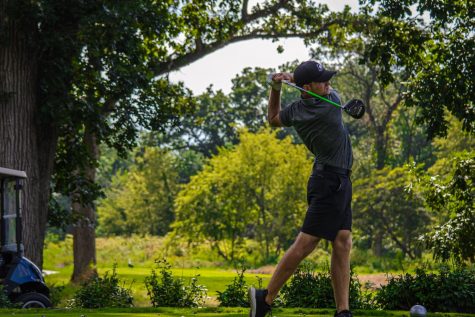 Senior Tommy Dunrise practices at Rich Harvest Farms on Aug. 28. Dunrise finished the first round tied with freshman teammate Ben Sluzas for first after shooting 67.