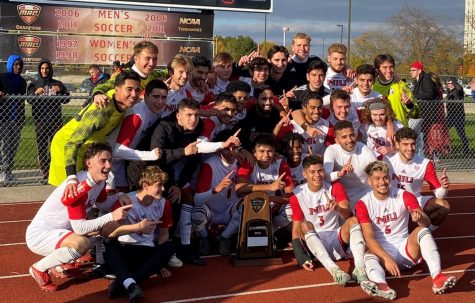 The NIU mens soccer team poses with the Mid-American Conference regular season trophy after a 2-1 victory over Akron on Oct. 30, 2021. (Noah Silver | Northern Star)