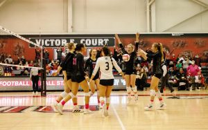 The volleyball team celebrates after scoring a point against Toledo on Oct. 22.