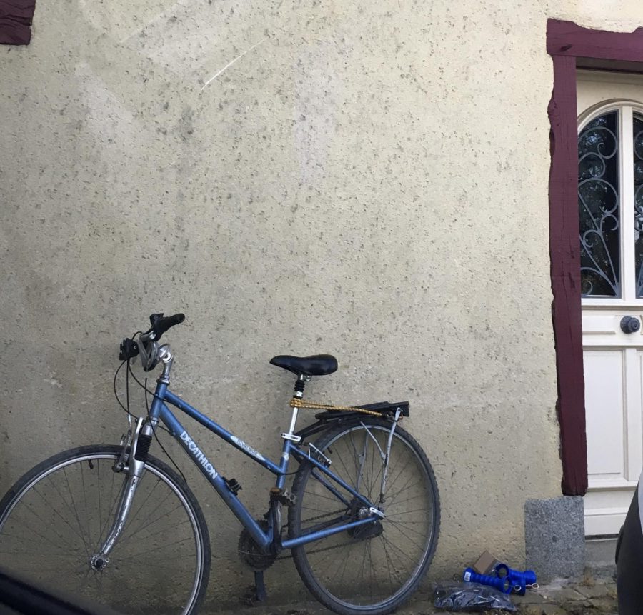 A bicycle leaning against a wall in Brittany, France.