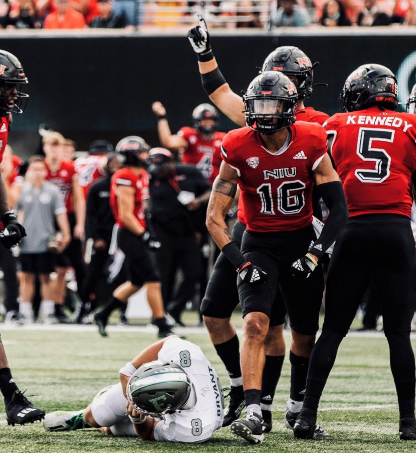 Redshirt junior linebacker Dillon Thomas celebrates after sacking EMU senior quarterback Ben Bryant in NIUs 27-20 win Saturday at Huskie Stadium. Thomas had two sacks in the victory.