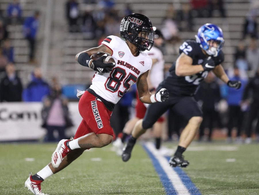 Then-COVID-freshman+wide+reciever+Trayvon+Rudolph+rushes+past+defenders+on+his+way+to+a+75-yard+touchdown+run+in+NIUs+33-27+victory+over+Buffalo+on+Nov.+17.+Rudolph+led+all+NIU+receivers+in+2021+with+51+receptions+for+892+receiving+yards.