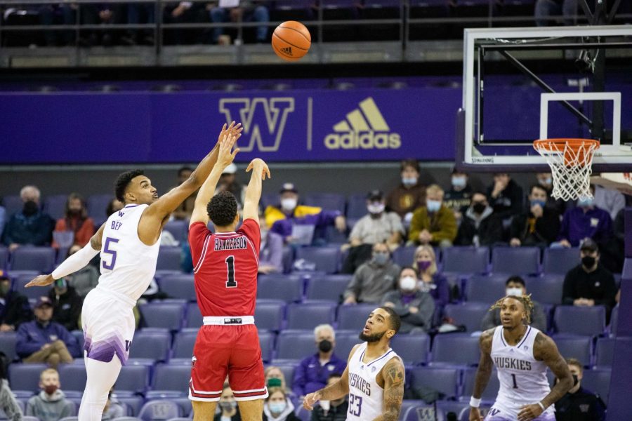 Senior guard Trendon Hankerson puts up a three-point shot over Washington senior guard Jamal Bey in NIU's win over Washington on Nov. 9 in Seattle. Hankerson scored a game-high 28 points with six made three pointers.