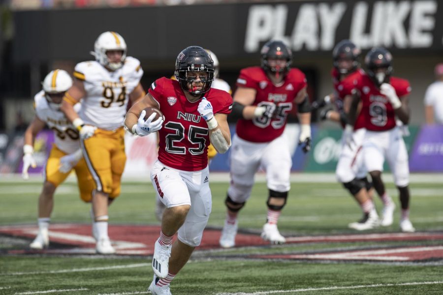 Redshirt senior running back Clint Ratkovich runs down the field during NIUs game on Sept. 11 at Huskie Stadium against Wyoming. Ratkovich has 12 touchdowns this season after transferring in from Western Illinois.