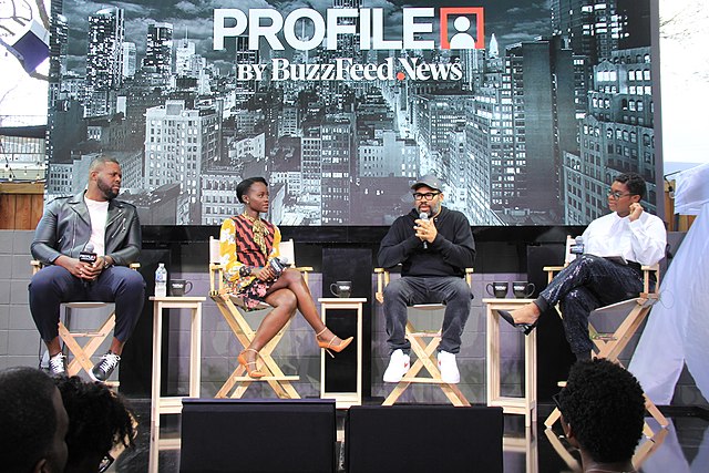 Director Jordan Peele and select cast members of Us on a panel. 