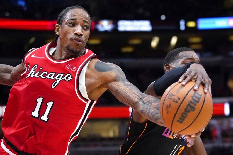 Chicago Bulls forward DeMar DeRozan, left, and Miami Heat center Bam Adebayo reach for a rebound on Saturday, Nov. 27, 2021. Through December, DeRozan is proving to be a valuable pickup for the Bulls. 