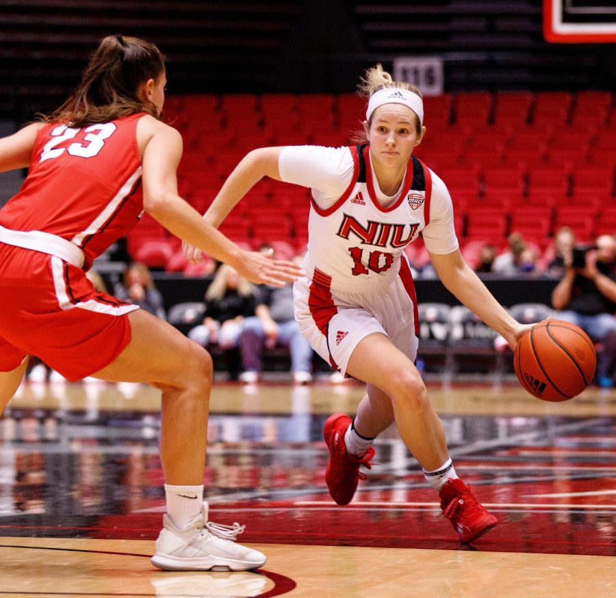 Junior guard Chelby Koker (right) dribbles past a defender in NIU's exhibition game against Benedictine on Oct. 29. 
