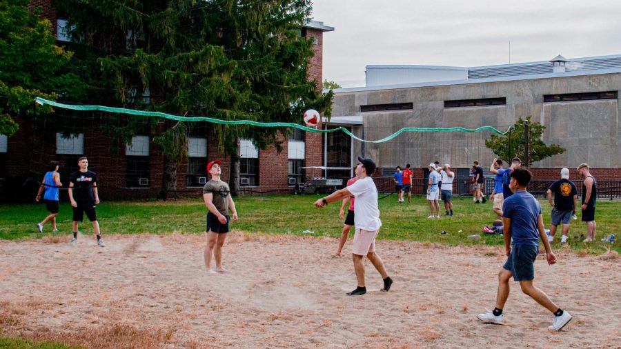 Matthew Niziolek, Senior in Sports Management Spikes the ball towards 
Drew Miller, Freshman in Finance in a friendly volleyball game opposite to Neptune Dining Hall.