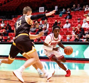 Junior guard Kaleb Thornton drives by two St. Francis defenders in NIUs 80-57 victory over the Fighting Saints at the Convocation Center on Oct. 30.