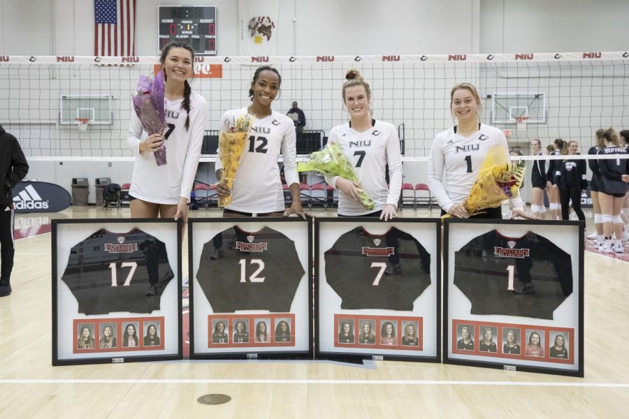 Seniors  middle blockers Angie Gromos (left) and Jasmine Kemp, setter Grace Balensiefer and defensive specialist Miranda Karlen recieve framed jerseys and flowers in a pre-game ceremony on Nov. 13. The group make up the graduating class of players on this years volleyball team.