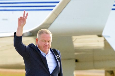 New LSU football coach Brian Kelly gestures to fans after his arrival at Baton Rouge Metropolitan Airport, Tuesday, Nov. 30, 2021, in Baton Rouge, La. Kelly, formerly of Notre Dame, is said to have agreed to a 10-year contract with LSU worth $95 million plus incentives.