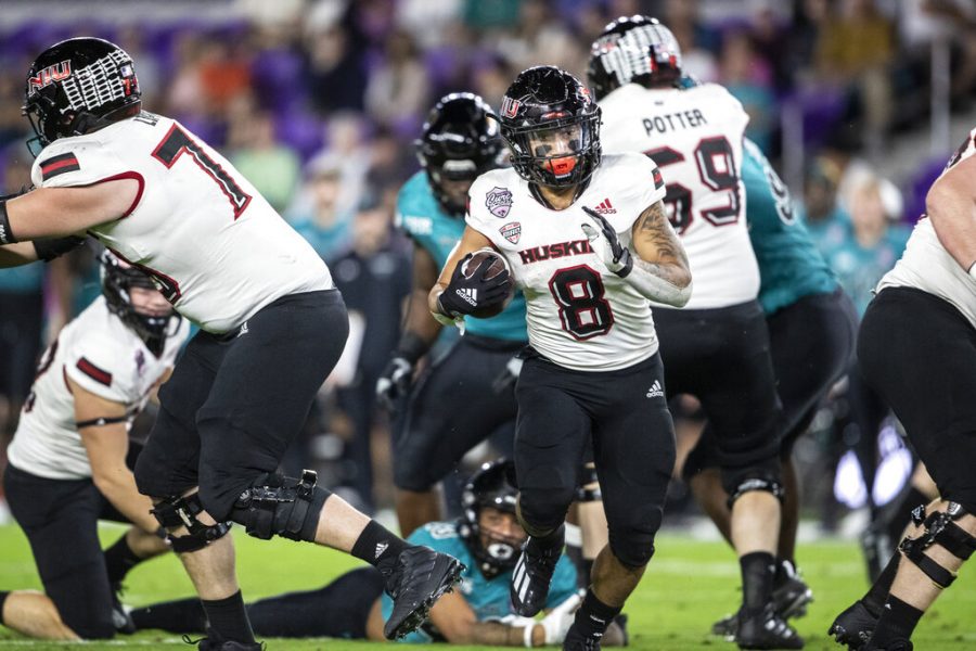 Northern Illinois running back Jay Ducker (8) runs the ball against Coastal Carolina during the Cure Bowl NCAA college football game in Orlando, Fla., Friday, Dec. 17, 2021. 