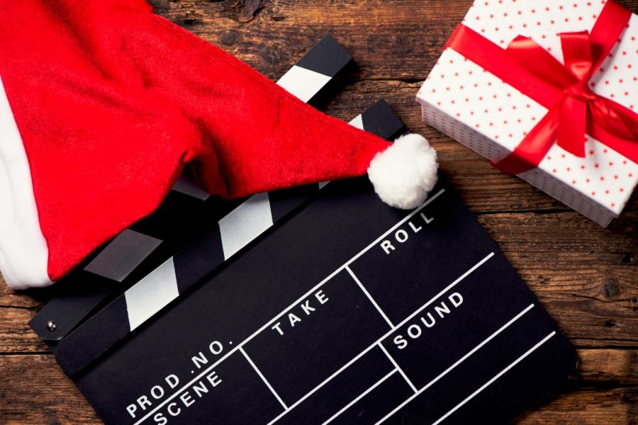 A clapperboard next to a Santa hat.