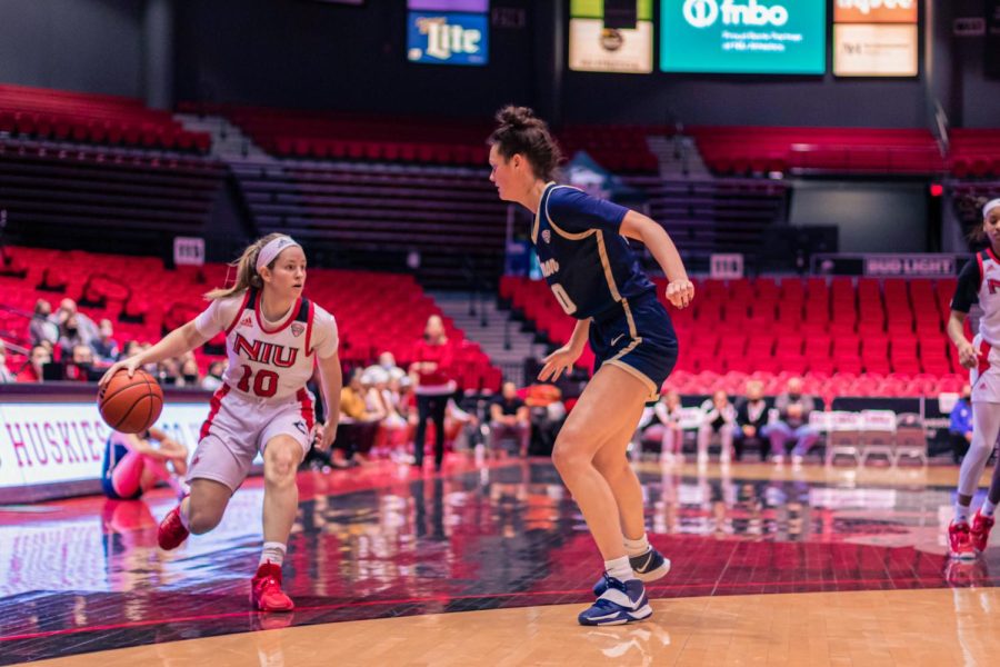 Junior guard Chelby Koker prepares to engage with an Akron player in January. Koker surpassed a total of 1,000 career points scored in NIUs 79-67 victory over Akron in DeKalb last semester.