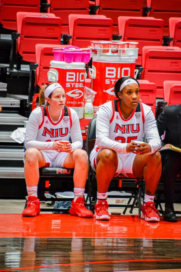 Junior guard Chelby Koker and junior forward AJah Davis sit on the bench during Wednesdays loss to Ball State University.