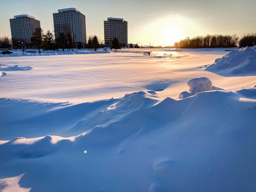 The sunset gleamed coral hues over the fresh snow that had accumulated over the Grant Towers parking lot.