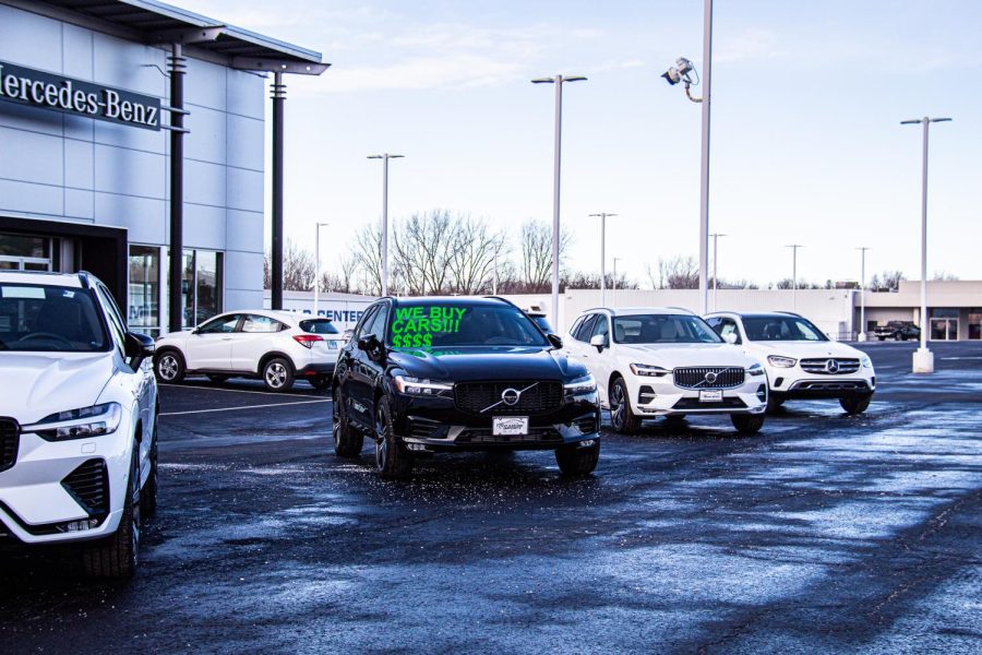 Cars for sale in a car dealership parking lot. The price of new and used cars has increased. 