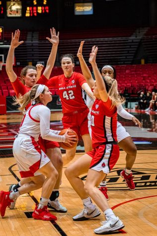 Womens basketball junior guard Chelby Koker attempts to navigate through a wave of Ball State defenders during an overtime loss to the Cardinals on Jan. 5 in DeKalb