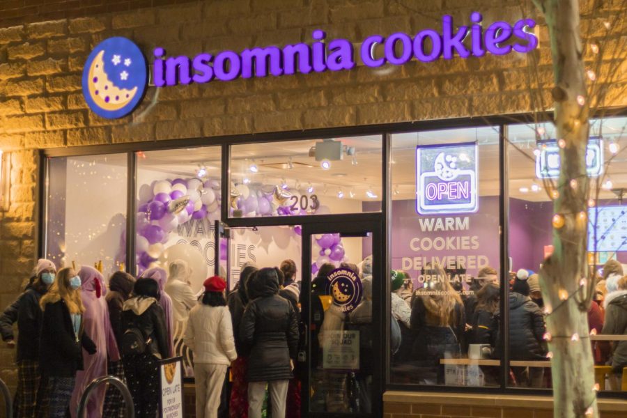 A photograph of a line of customers waiting to get into Insomnia Cookies during the stores grand opening PJ party.