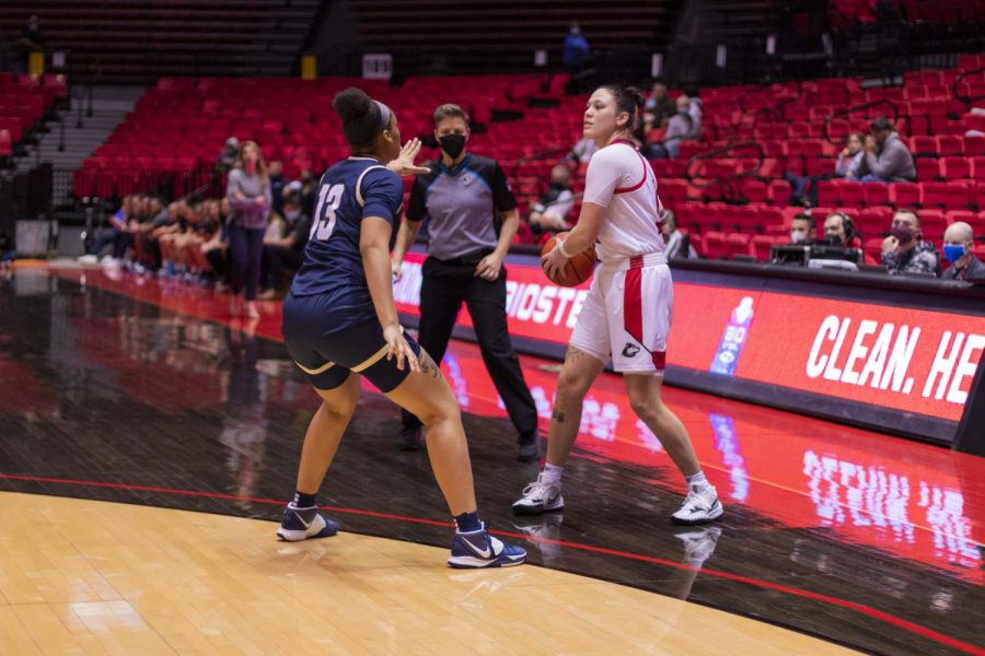 Akron junior forward Lonasia Brewer defends NIU senior forward Mikayla Brandon during a Monday night game in the Convocation Center in DeKalb. The Huskies went on to win 79-67.