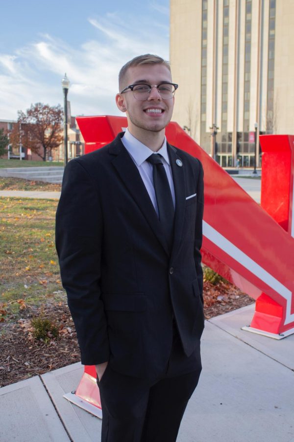 Jacob Burg stands in front of the NIU letters at the MLK Commons. Burg is Deputy Speaker of the Senate, Chair of the Board of Elections, and acting Election Commissioner in SGA. 