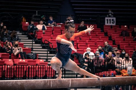 Senior Morgan Hooper performs on the balance beam in the third rotation of the NIU Tri-Meet on Feb. 4 at the Convocation Center in DeKalb. Hooper competed in all four events at the meet, her best performance taking place on floor exercise with a score of 9.875.