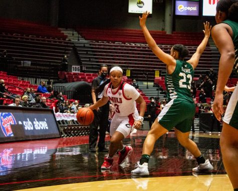 NIU sophomore guard Jayden Marable maneuvers past EMU freshman guard Kyndal Lewis during Wednesdays conference matchup at the Convocation Center in DeKalb. Marable finished the game with 12 points, the fourth-best scorer for the Huskies in the 72-65 victory over the Eagles. (Alexander Pyevich/Northern Star)
