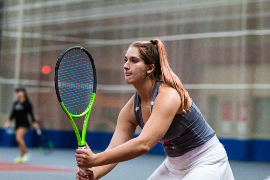 Freshman Reagan Welch assumes the ready position during a match against the University of St. Francis on Feb. 11. Welch earned victories in two singles matches and one doubles match during NIU's weekend trip in the state of Iowa. (Summer Fitzgerald | Northern Star) 